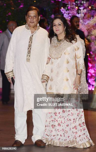 Indian Bollywood film director David Dhawan poses for a picture with his wife Karuna as they attend the pre-engagement party of India's richest man...