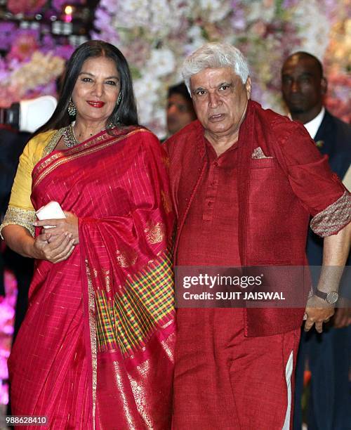 Indian poet, lyricist and screenwriter Javed Akhtar and wife and actress Shabana Azmi pose for a picture as they attend the pre-engagement party of...