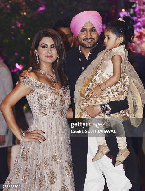 Indian Cricketer Harbhajan Singh poses for a picture with his wife and actress Geeta Basra along with their daughter Hinaya as they attend the...