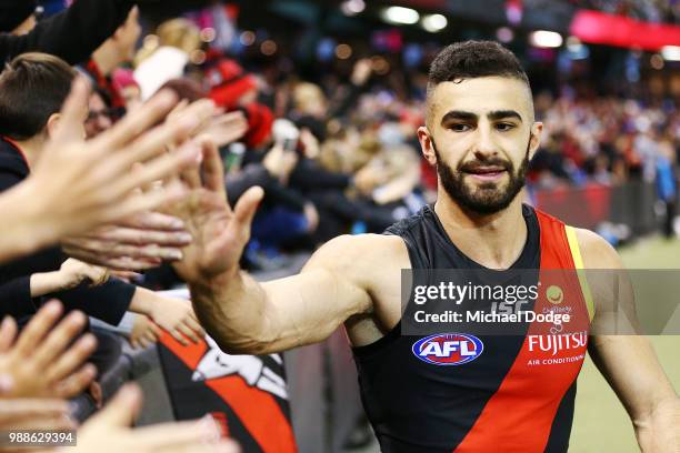 Adam Saad of the Bombers celebrates the win with fans during the round 15 AFL match between the Essendon Bombers and the North Melbourne Kangaroos at...