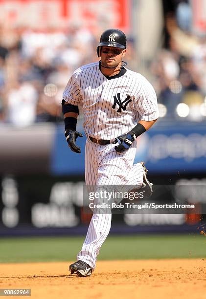 Nick Swisher of the New York Yankees rounds second base after hitting a home run against the Chicago White Sox at Yankee Stadium on May 01, 2010 in...