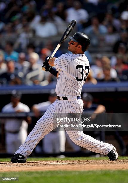 Nick Swisher of the New York Yankees hits a home run against the Chicago White Sox at Yankee Stadium on May 01, 2010 in the Bronx borough of...