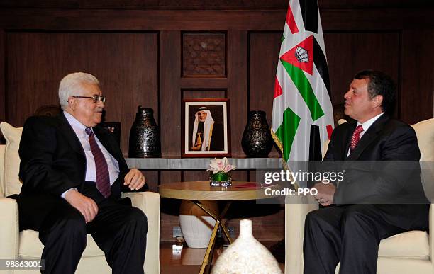 In this handout image supplied by the Palestinian Press Office , Palestinian President Mahmoud Abbas speaks with King Abdullah II of Jordan during a...