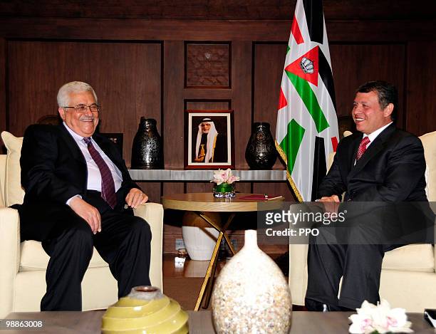 In this handout image supplied by the Palestinian Press Office , Palestinian President Mahmoud Abbas laughs with King Abdullah II of Jordan during a...