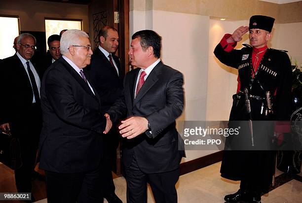 In this handout image supplied by the Palestinian Press Office , Palestinian President Mahmoud Abbas shakes hands with King Abdullah II of Jordan...