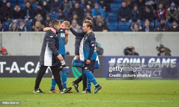 Hoffenheim's Felix Passlack comforts his team colleague Philipp Ochs who leaves the field after getting injured during the Europa League group C...