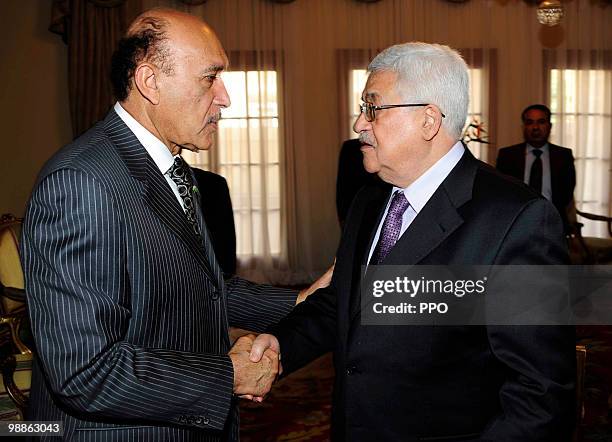 In this handout image supplied by the Palestinian Press Office , Palestinian President Mahmoud Abbas shakes hands with Egypt's Chief of Intelligence...