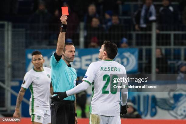 Referee Orel Grinfeld shows the red card to Razgard's Claudiu Keserue during the Europa League group C soccer match between 1899 Hoffenheim and...