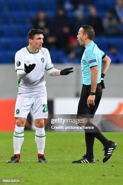 Razgrad's Claudiu Keserie talks to referee Orel Grinfeld after seeing the red card during the Europa League group C soccer match between 1899...