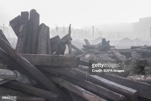 Outside the Barracks in Belgrade, wooden railway sleepers are scattered in piles. The Barracks in Belgrade were abandoned buildings behind the...