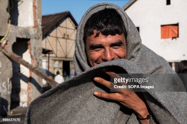 Refugee uses a UNHCR blanket to stay warm during a cold Serbian winter. The Barracks in Belgrade were abandoned buildings behind the central train...