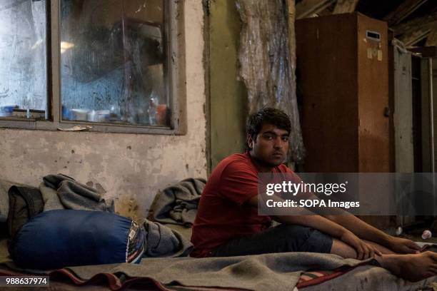 Migrant from Pakistan sits on a bed in the abandoned building. The Barracks in Belgrade were abandoned buildings behind the central train station...