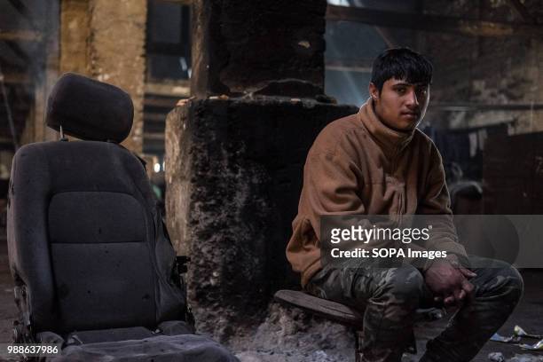 Deaf refugee from Afghanistan sits in the abandoned buildings known as the barracks. The Barracks in Belgrade were abandoned buildings behind the...