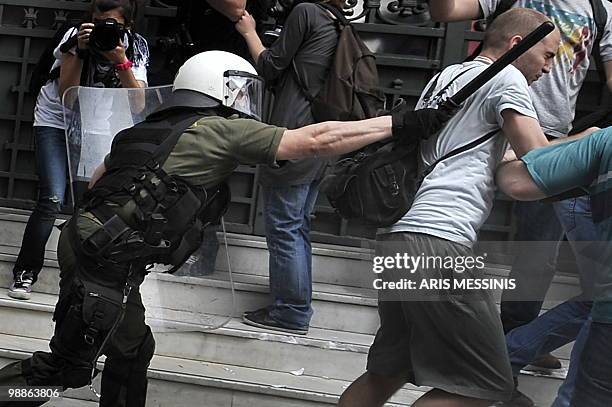 Greek riot policemen clash with protestors in front of the National Bank of Greece in the center of Athens on May 5, 2010. A nationwide general...