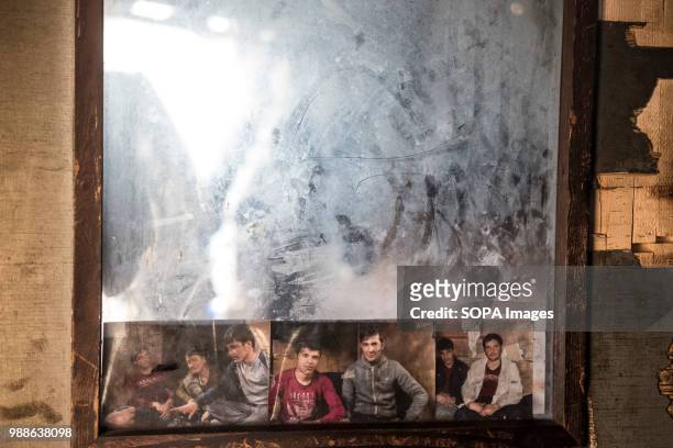 In an abandoned train carriage close to the Barracks in Belgrade refugees and migrants have stuck pictures of friends and family to a mirror. The...