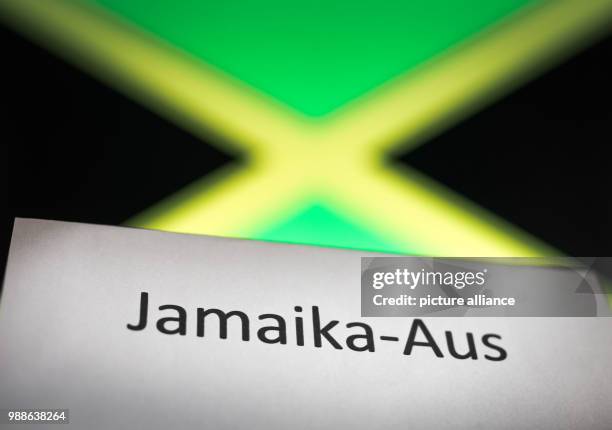 The word 'Jamaika-Aus' is written on a paper held up in front of a computer screen with the flag of Jamaica in Wiesbaden, Germany, 8 December 2017....