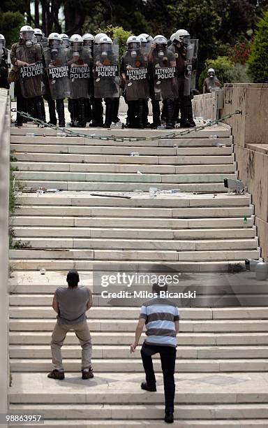 Protesters taunt police outside parliament on May 5, 2010 in Athens, Greece. Three people have died after protesters set fire to the Marfin Egnatia...