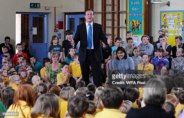 British opposition Conservative party Leader David Cameron gestures as he talks to pupils during an election campaign visit to Ysgol Dafydd Llwyd...