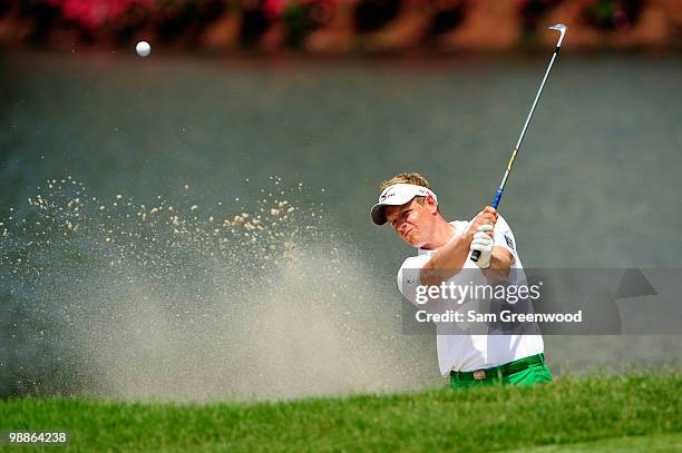 Luke Donald of England hits a shot from a bunker during a practice round prior to the start of THE PLAYERS Championship held at THE PLAYERS Stadium...