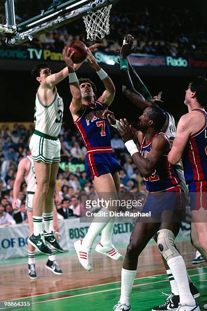 Kelly Tripucka of the Detroit Pistons goes up for a shot against Kevin McHale of the Boston Celtics during a game played in 1985 at the Boston Garden...