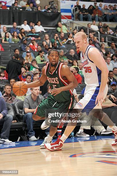 John Salmons of the Milwaukee Bucks drives the ball against Chris Kaman of the Los Angeles Clippers at Staples Center on March 17, 2010 in Los...