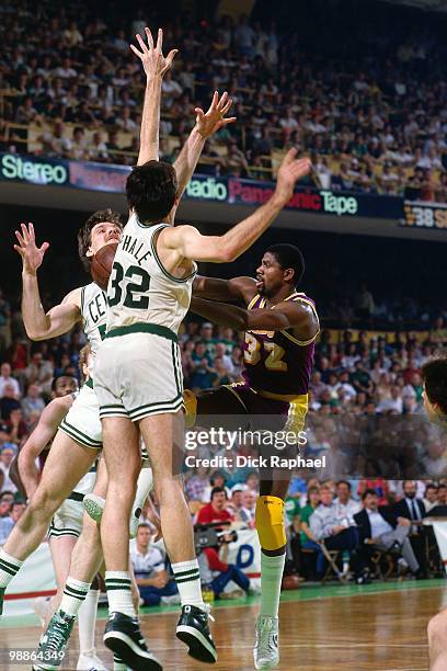 Magic Johnson of the Los Angeles Lakers passes against Kevin McHale of the Boston Celtics during the 1985 NBA Finals at the Boston Garden in Boston,...