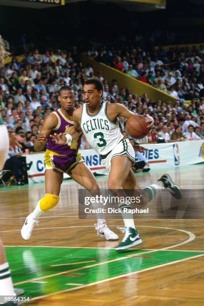 Dennis Johnson of the Boston Celtics drives to the basket against Byron Scott of the Los Angeles Lakers during the 1985 NBA Finals at the Boston...