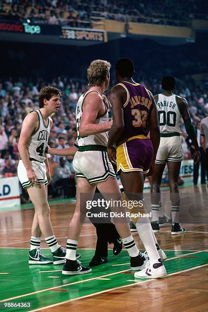 Larry Bird of the Boston Celtics defends against Magic Johnson of the Los Angeles Lakers during the 1985 NBA Finals at the Boston Garden in Boston,...