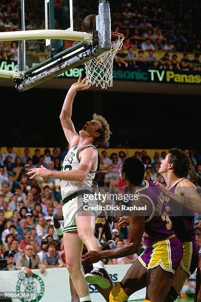 Larry Bird of the Boston Celtics shoots against Magic Johnson of the Los Angeles Lakers during the 1985 NBA Finals at the Boston Garden in Boston,...