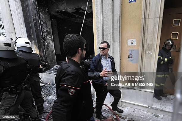 Marfin Investment Group chairman Andreas Vgenopoulos arrives at a Marfin bank branch in Athens where three employees died today due to firebombs...