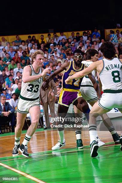 Larry Bird of the Boston Celtics cuts to the basket against James Worthy of the Los Angeles Lakers during the 1985 NBA Finals at the Boston Garden in...