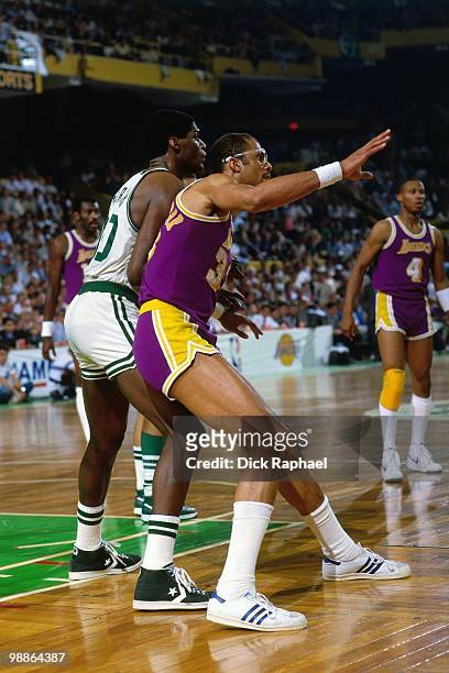 Kareem Abdul-Jabbar of the Los Angeles Lakers posts up against Robert Parish of the Boston Celtics during the 1985 NBA Finals at the Boston Garden in...