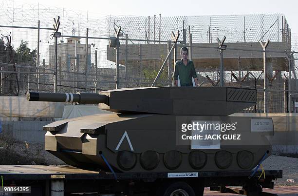 Truck carrying a mock tank with a cardboard cut-out of captured Israeli soldier Gilad Shalit is parked outside the Hadarim prison as Israeli...