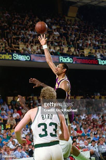 Kareem Abdul-Jabbar of the Los Angeles Lakers shoots against Larry Bird of the Boston Celtics during the 1985 NBA Finals at the Boston Garden in...