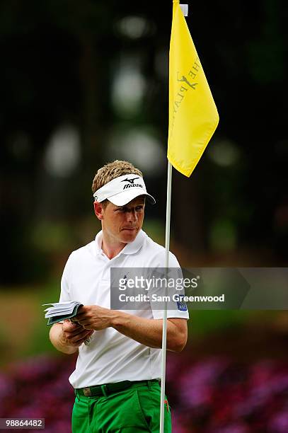 Luke Donald of England looks at his yardage book during a practice round prior to the start of THE PLAYERS Championship held at THE PLAYERS Stadium...