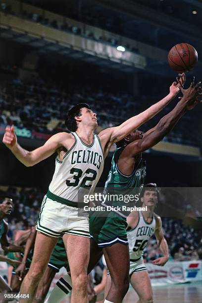 Kevin McHale of the Boston Celtics rebounds against the Dallas Mavericks during a game played in 1985 at the Boston Garden in Boston, Massachusetts....