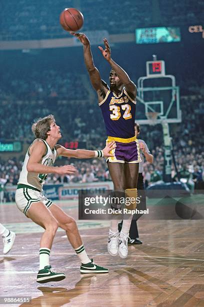 Magic Johnson of the Los Angeles Lakers shoots over Danny Ainge of the Boston Celtics during a game played in 1985 at the Boston Garden in Boston,...