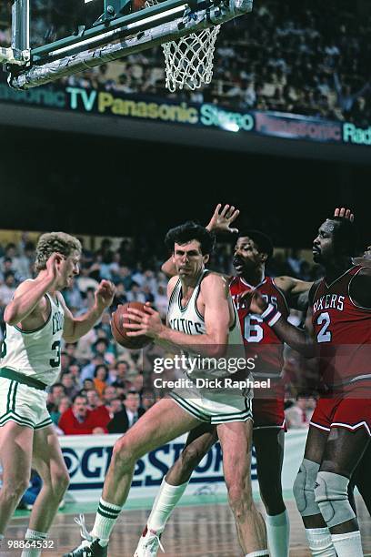 Kevin McHale of the Boston Celtics rebounds against the Philadelphia 76ers during a game played in 1985 at the Boston Garden in Boston,...