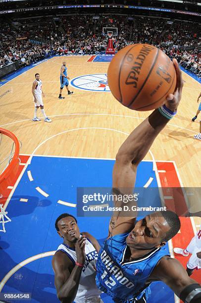 Dwight Howard of the Orlando Magic puts a shot up against Samuel Dalembert of the Philadelphia 76ers during the game on March 22, 2010 at the...