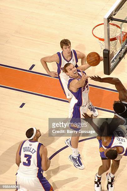 Louis Amundson of the Phoenix Suns reaches for a loose ball over the San Antonio Spurs in Game One of the Western Conference Semifinals during the...