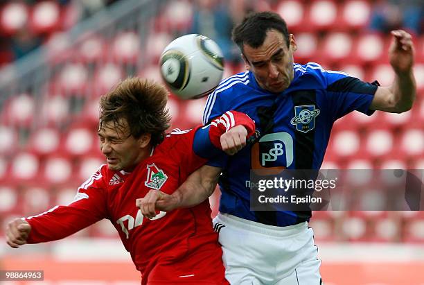 Dmitri Sychev of FC Lokomotiv Moscow battles for the ball with Dmitri Grachyov of FC Saturn Moscow Oblast during the Russian Football League...