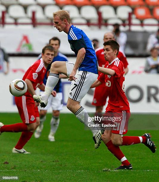 Dmitri Torbinski of FC Lokomotiv Moscow battles for the ball with Pyotr Nemov of FC Saturn Moscow Oblast during the Russian Football League...