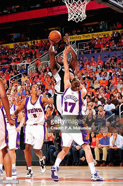 DeJuan Blair of the San Antonio Spurs goes up for a shot over Louis Amundson of the Phoenix Suns in Game One of the Western Conference Semifinals...