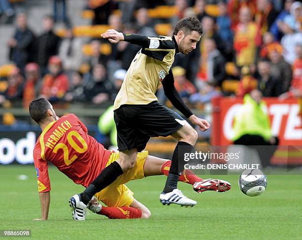 Lens's midfielder Adil Hermach vies with Grenoble's croatian forward Josip Tadic during the French L1 football match Lens vs. Grenoble on May 5, 2010...