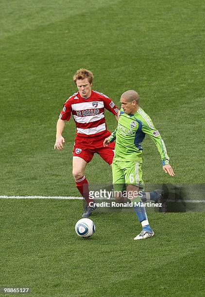 Midfielder Osvaldo Alonso of the Seattle Sounders dribbles the ball against Dax McCarty of FC Dallas at Pizza Hut Park on April 22, 2010 in Frisco,...