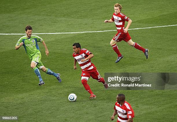 Midfielder David Ferreira of FC Dallas dribbles the ball against Brad Evans of the Seattle Sounders at Pizza Hut Park on April 22, 2010 in Frisco,...