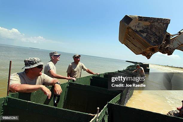 Alabama National Guard members Sergeant 1st Class James Clemmons, Sergeant 1st Class Shelton Lowery and Sergeant Troy Fitzhugh work on erecting a...