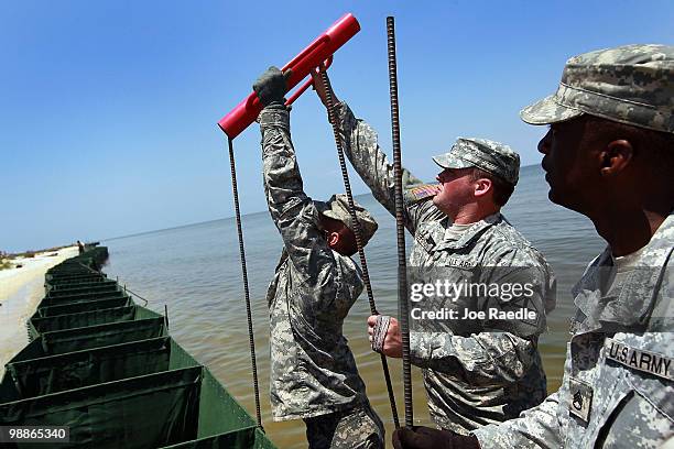 Alabama National Guard members erect a HESCO container barrier in an effort to protect the coast line from the massive oil spill in the Gulf of...