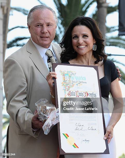 Tom LaBonge and Julia Louis-Dreyfus attend Julia Louis-Dreyfus' induction into the Hollywood Walk of Fame on May 4, 2010 in Hollywood, California.