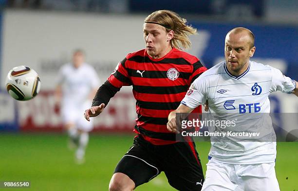 Dmitry Khokhlov of FC Dynamo Moscow battles for the ball with Dmitri Belorukov of FC Amkar Perm during the Russian Football League Championship match...